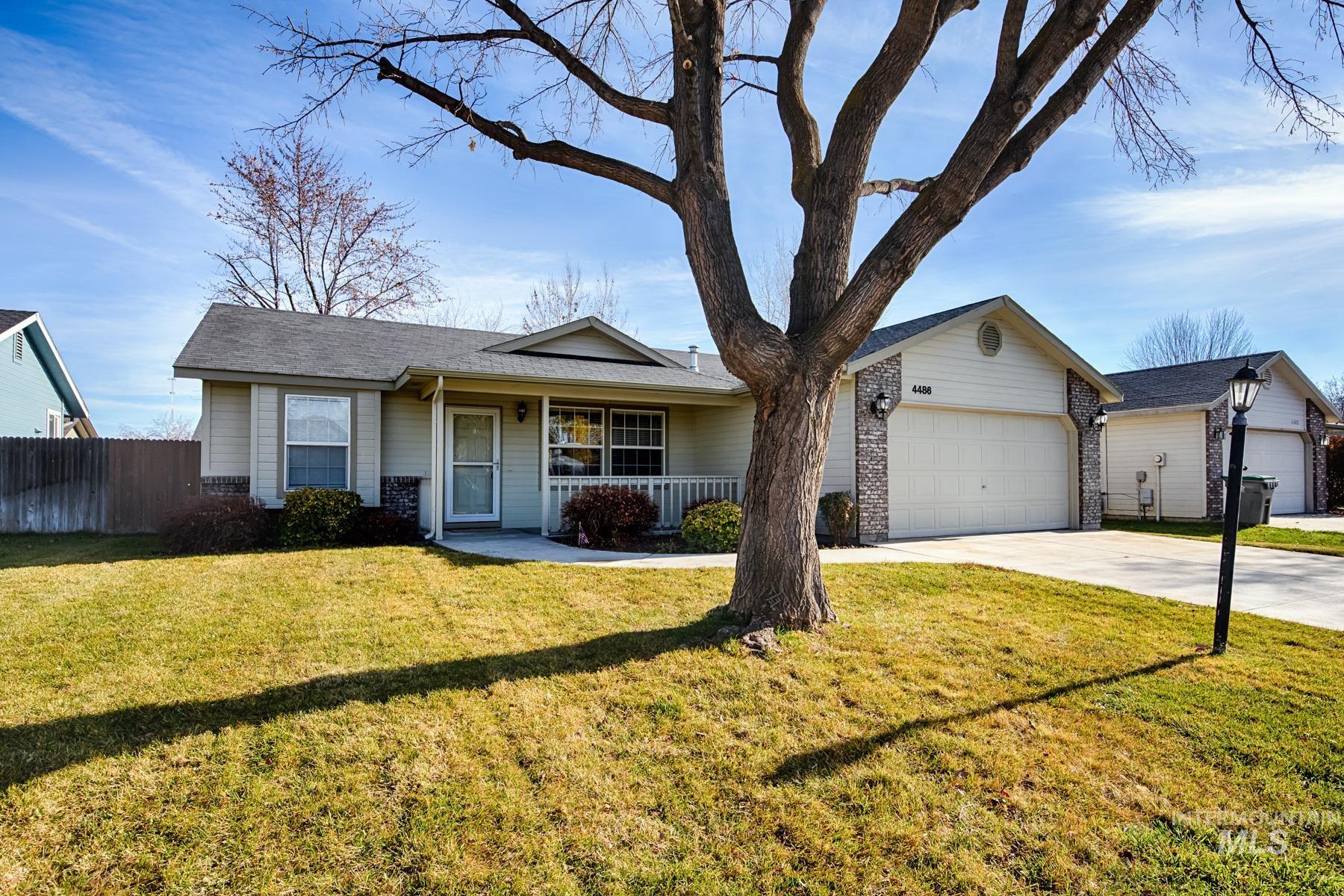 Single story home featuring a porch, concrete driveway, roof with shingles, and an attached garage