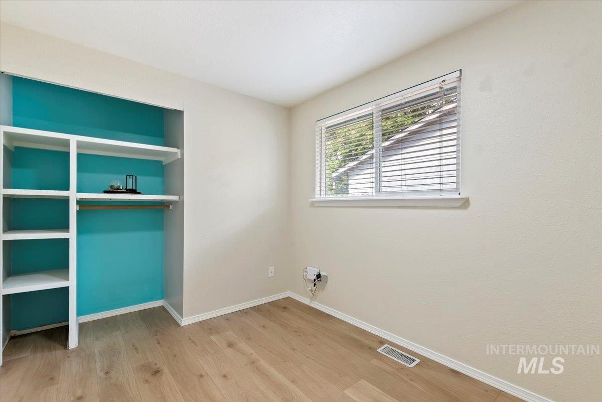 Washroom with light wood finished floors and baseboards