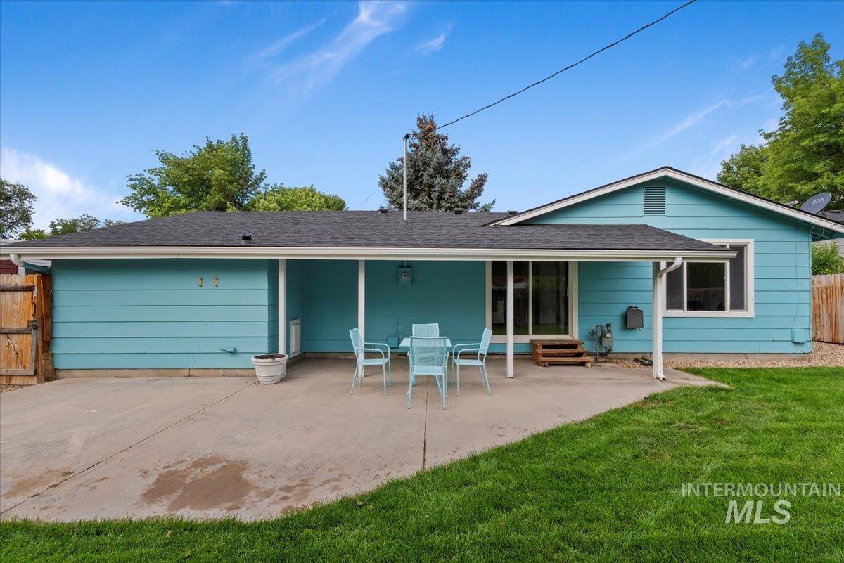 Rear view of property with a patio and a shingled roof