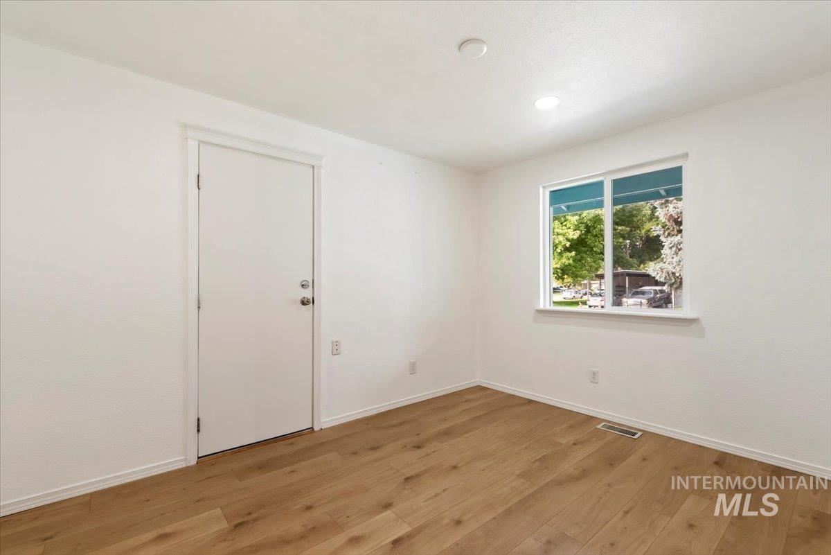Spare room with light wood finished floors and recessed lighting