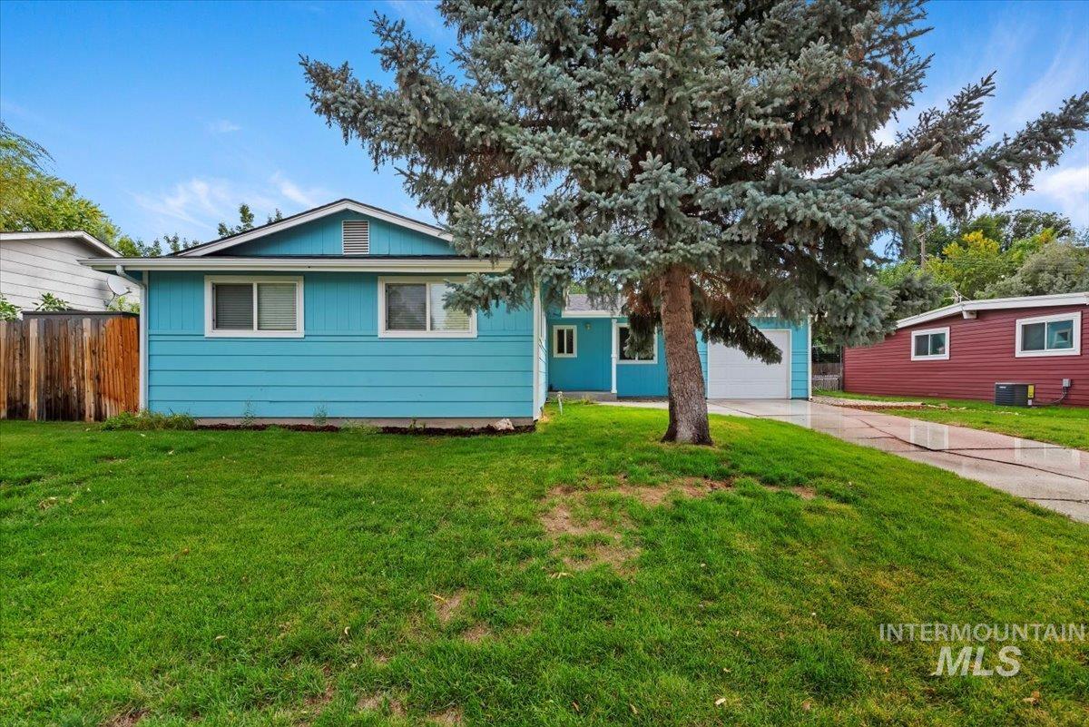 View of front of home featuring concrete driveway and a garage