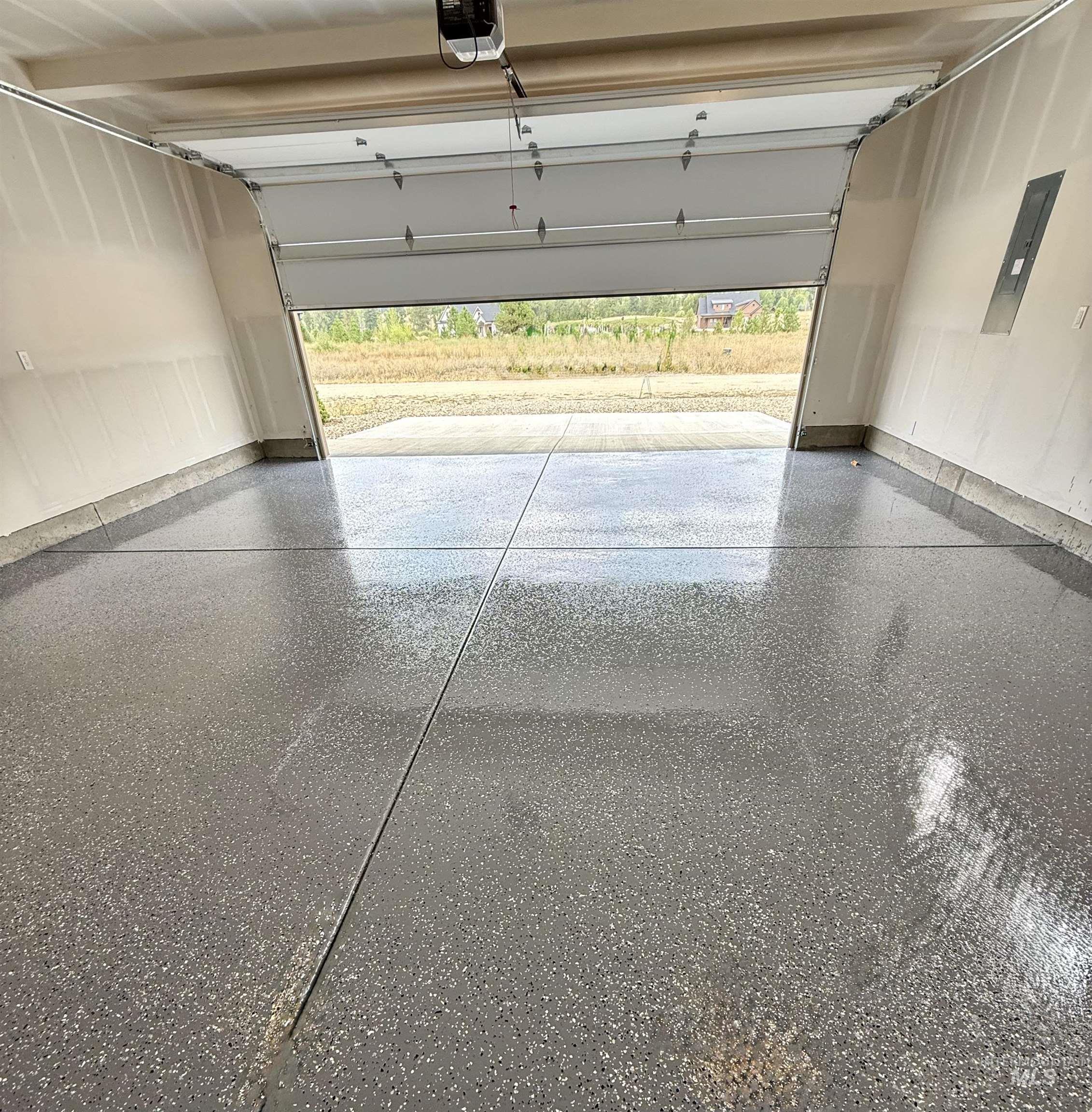 Garage with electric panel and a garage door opener