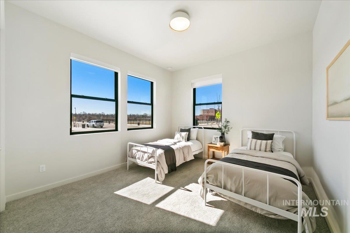 Bedroom featuring carpet flooring and baseboards