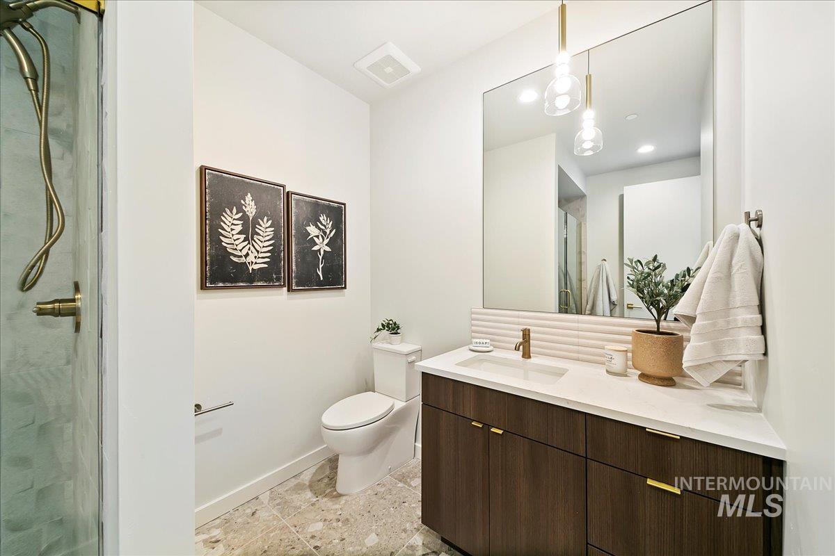 Bathroom with a stall shower and vanity