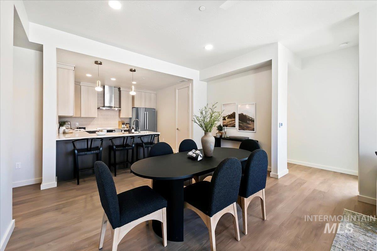Dining space featuring light wood finished floors and recessed lighting