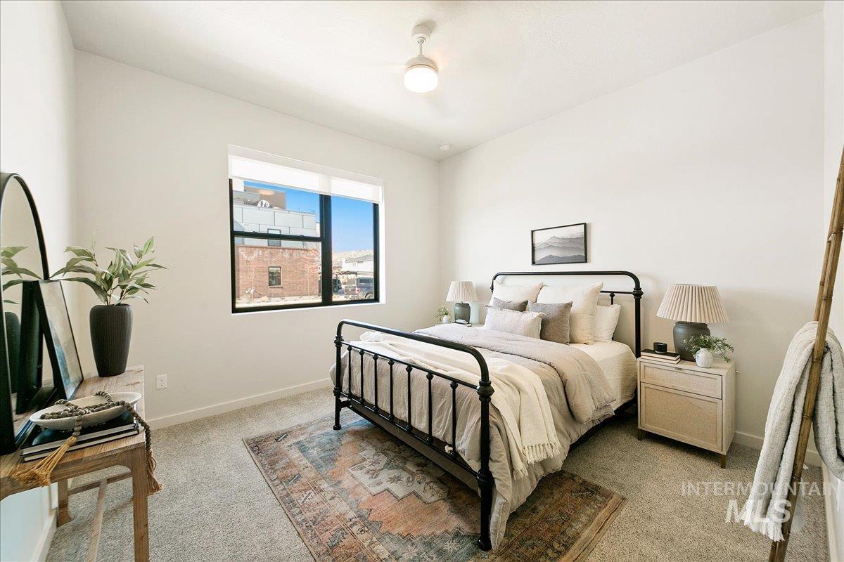 Bedroom featuring light carpet and baseboards