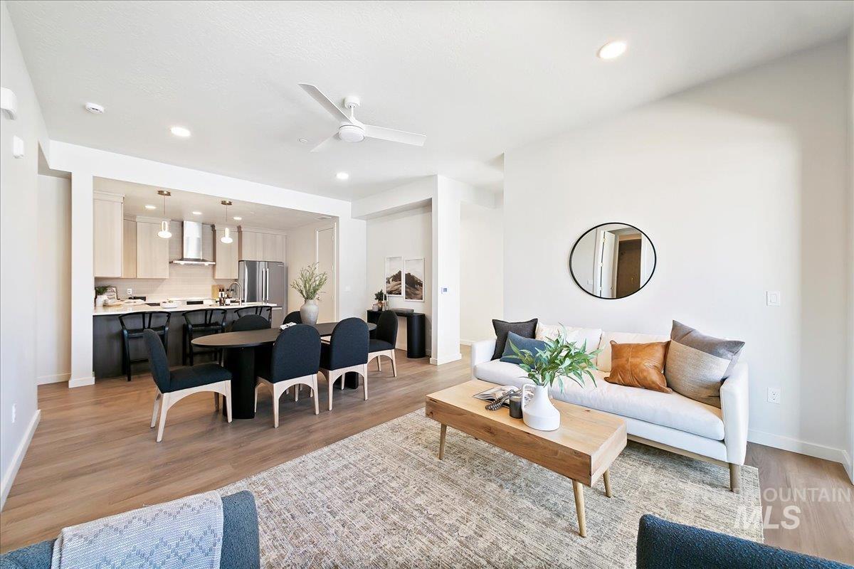 Living area featuring a ceiling fan, recessed lighting, and light wood-type flooring