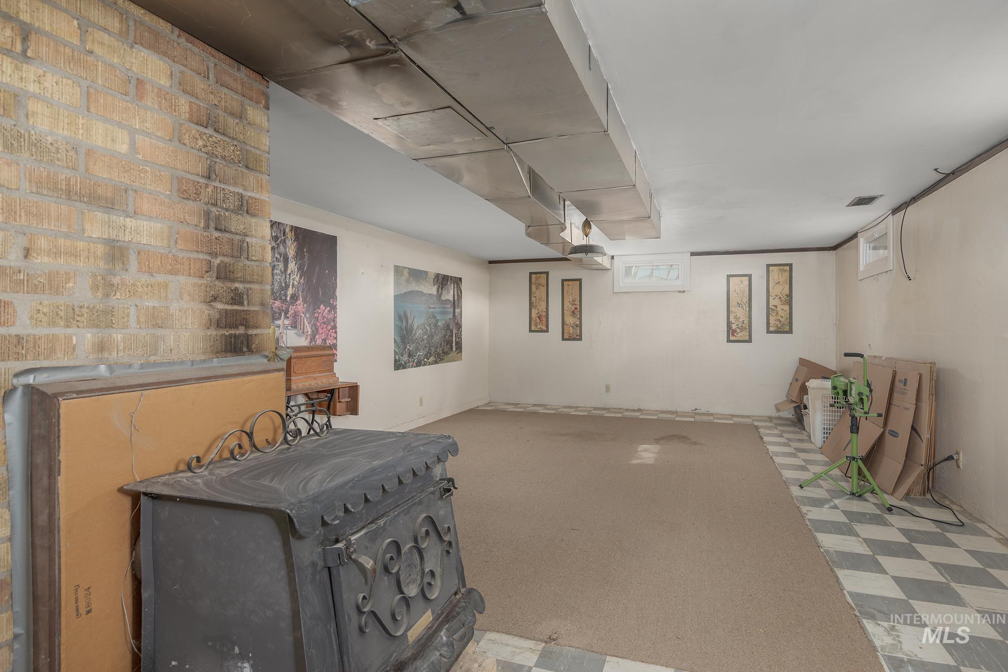 Below grade area featuring light floors