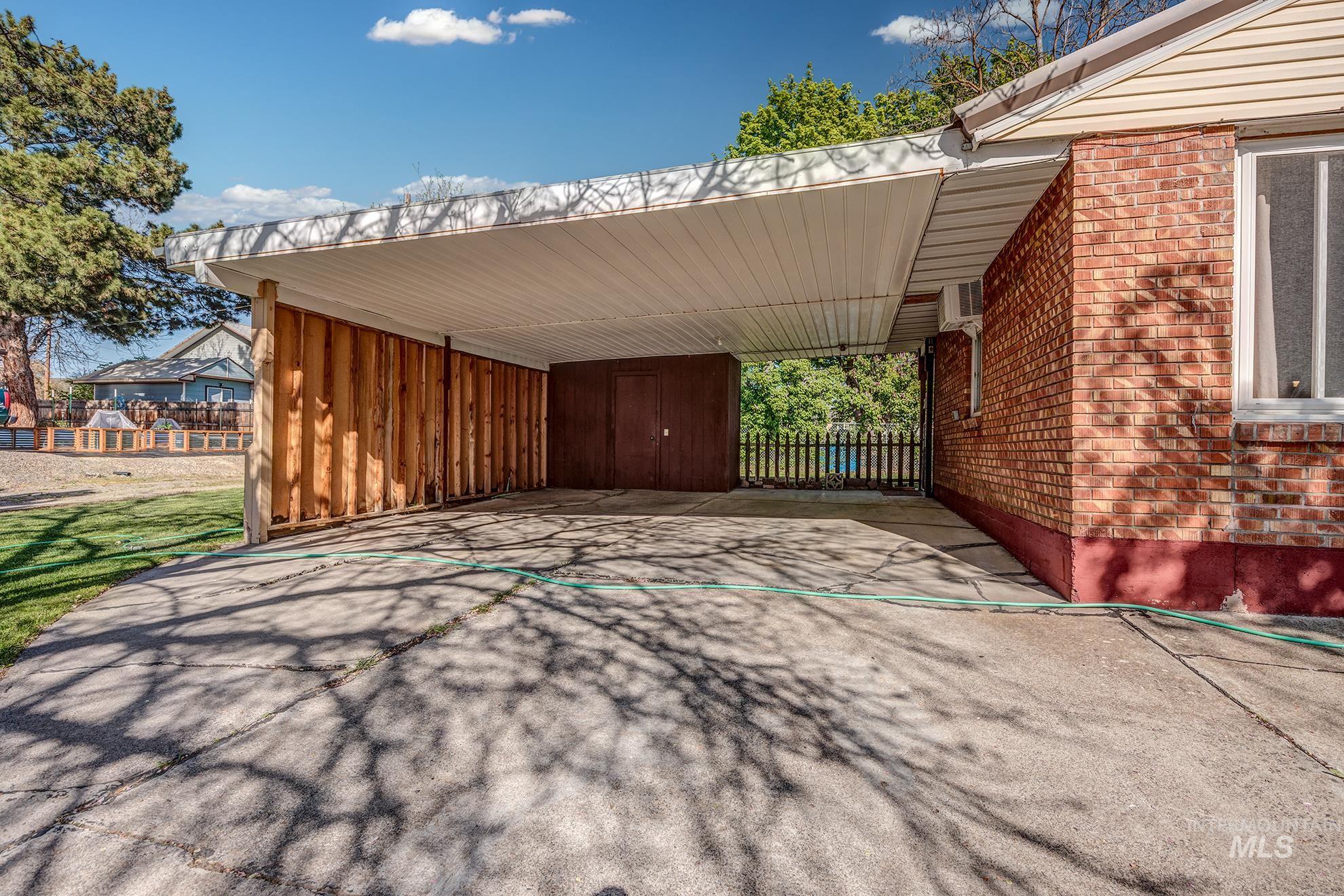 View of patio with a carport