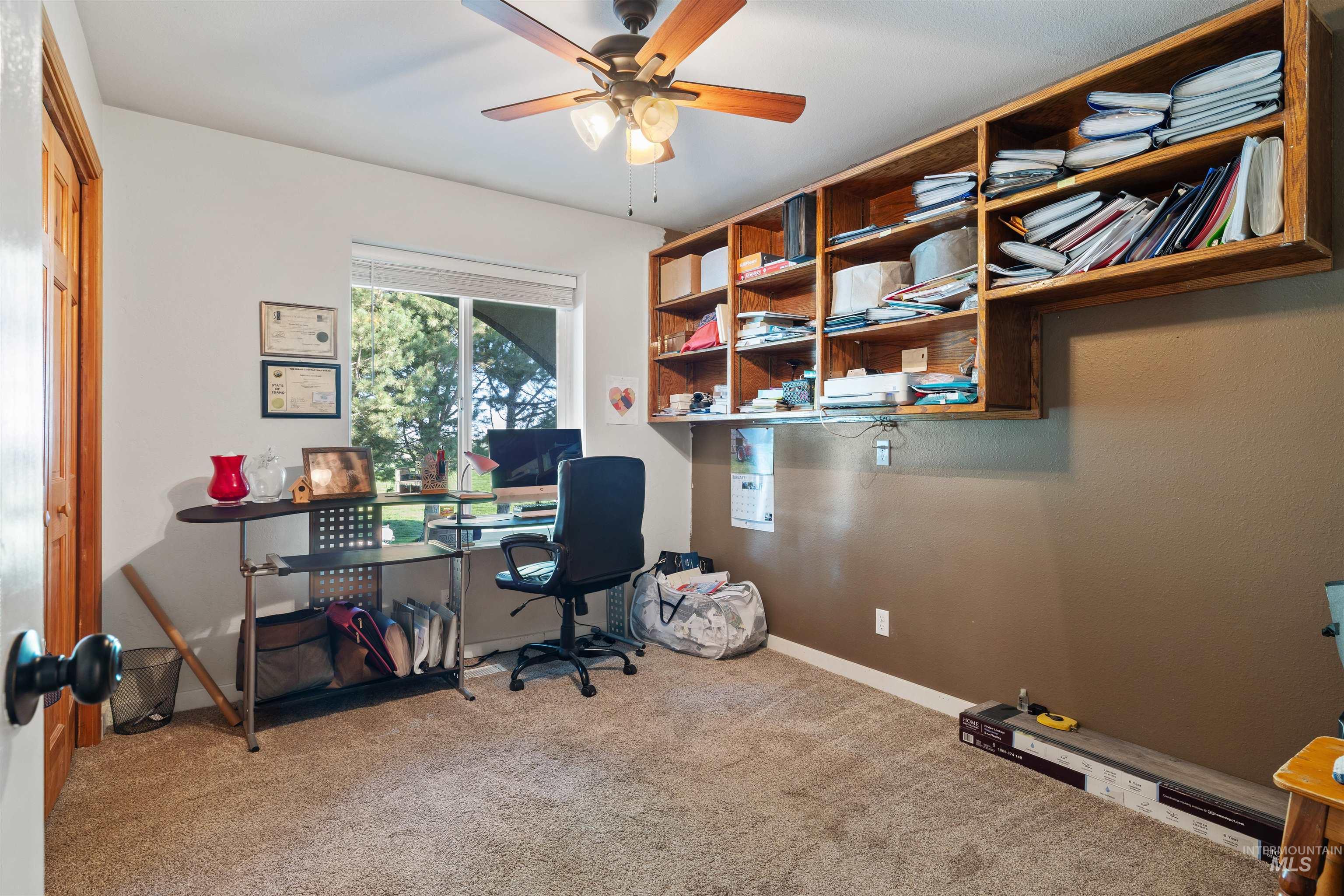 Office featuring light colored carpet and ceiling fan