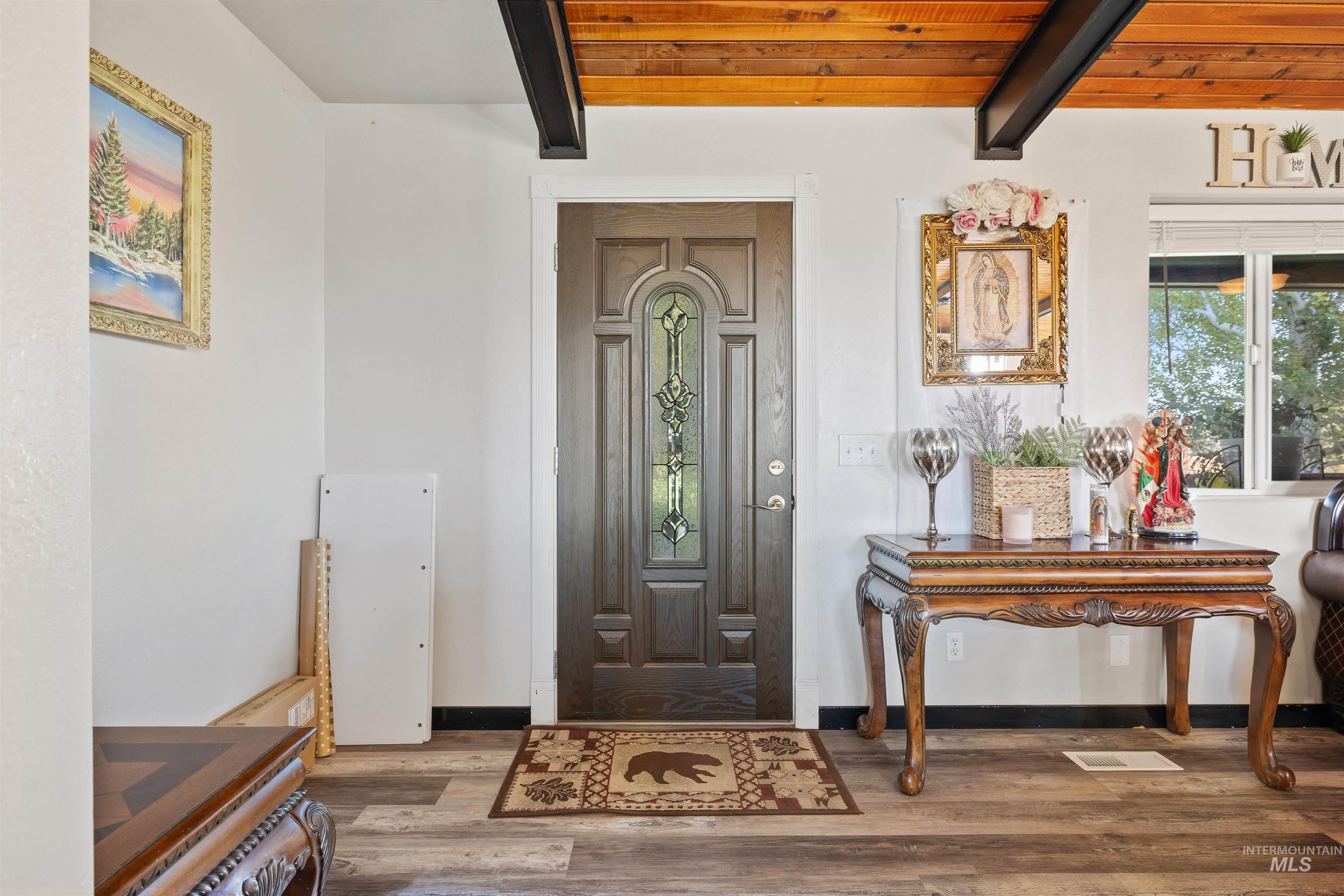 Entrance foyer with beamed ceiling and wood finished floors