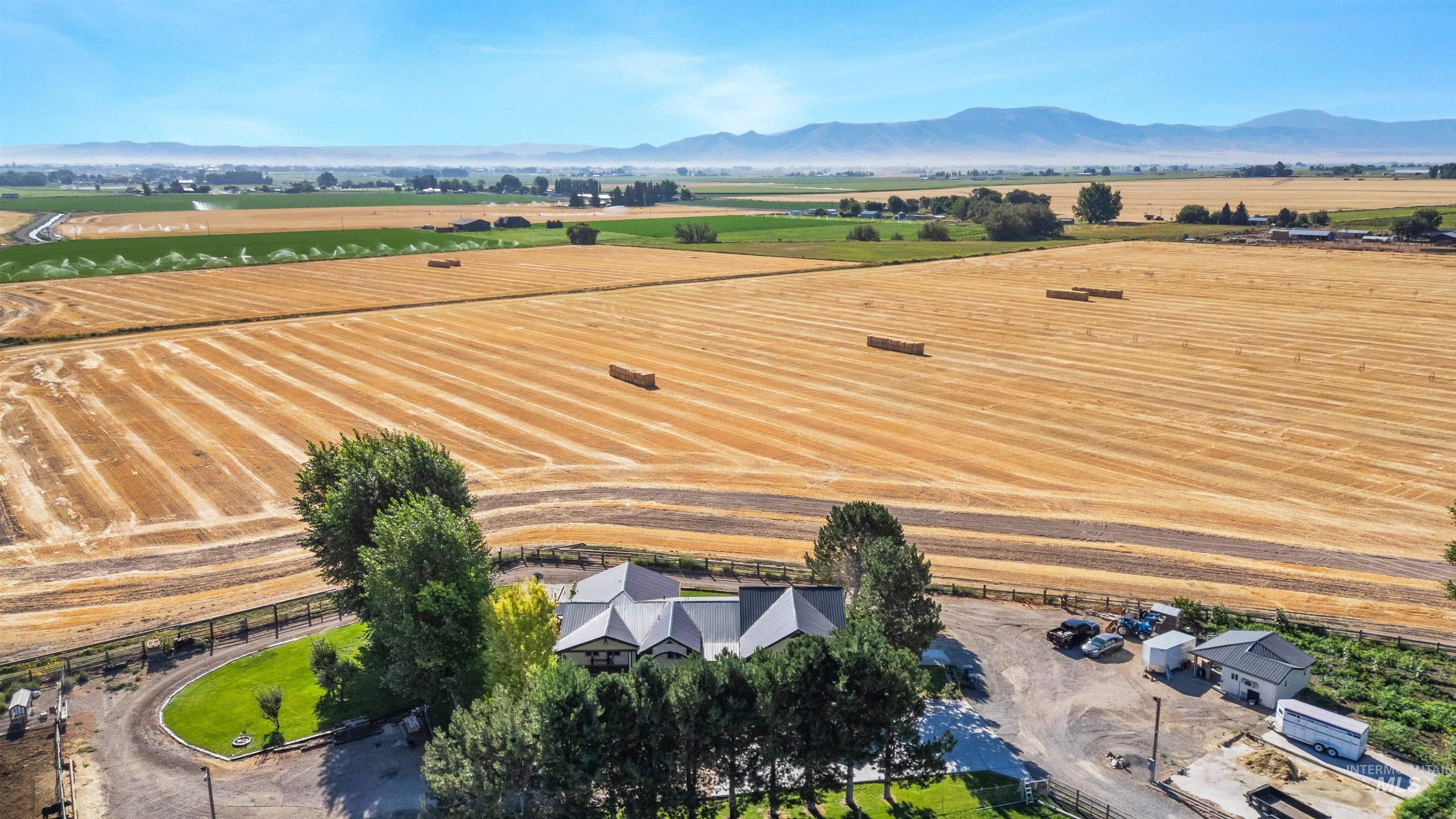 View of rural area featuring a mountain backdrop and abundant farmland