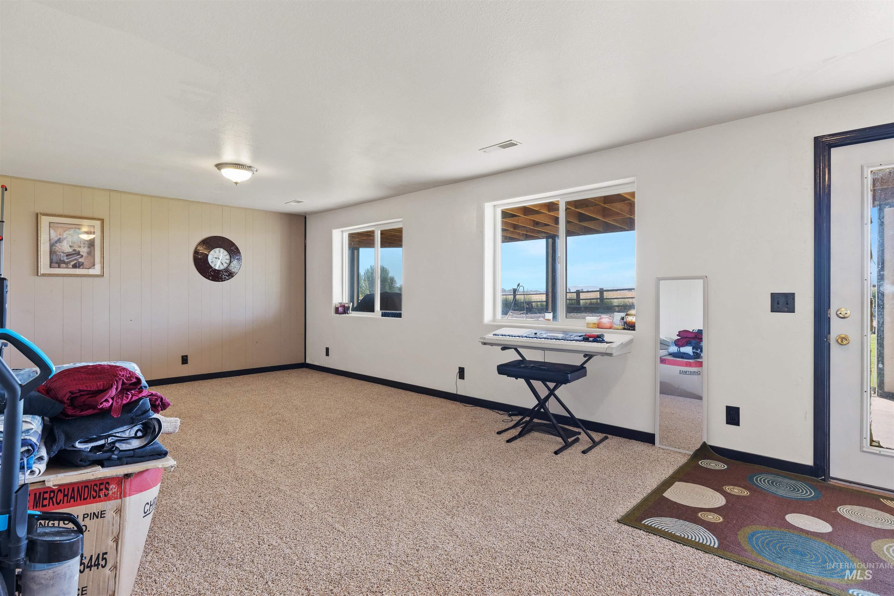 Entryway with light colored carpet and baseboards