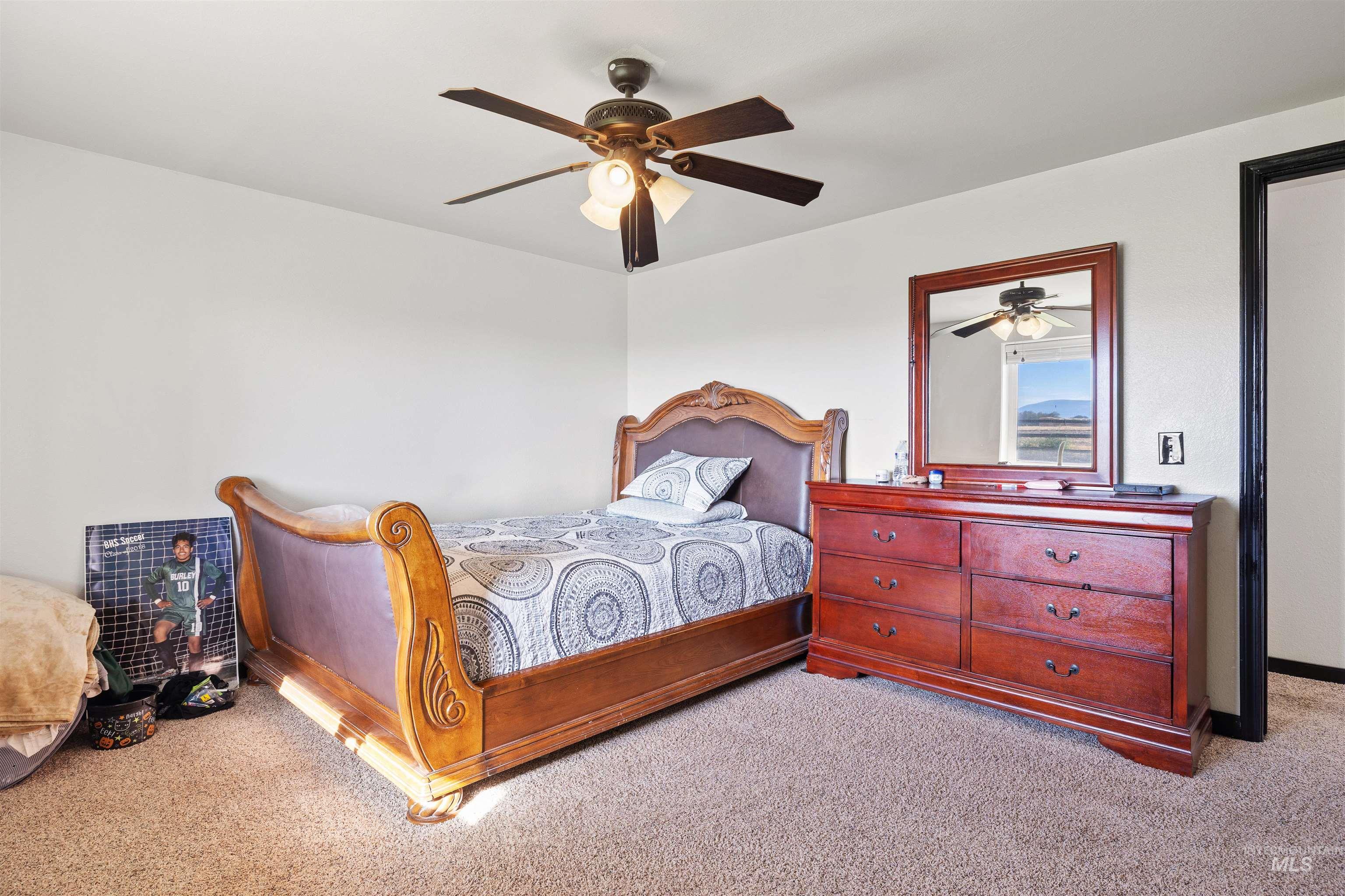 Bedroom featuring carpet and a ceiling fan