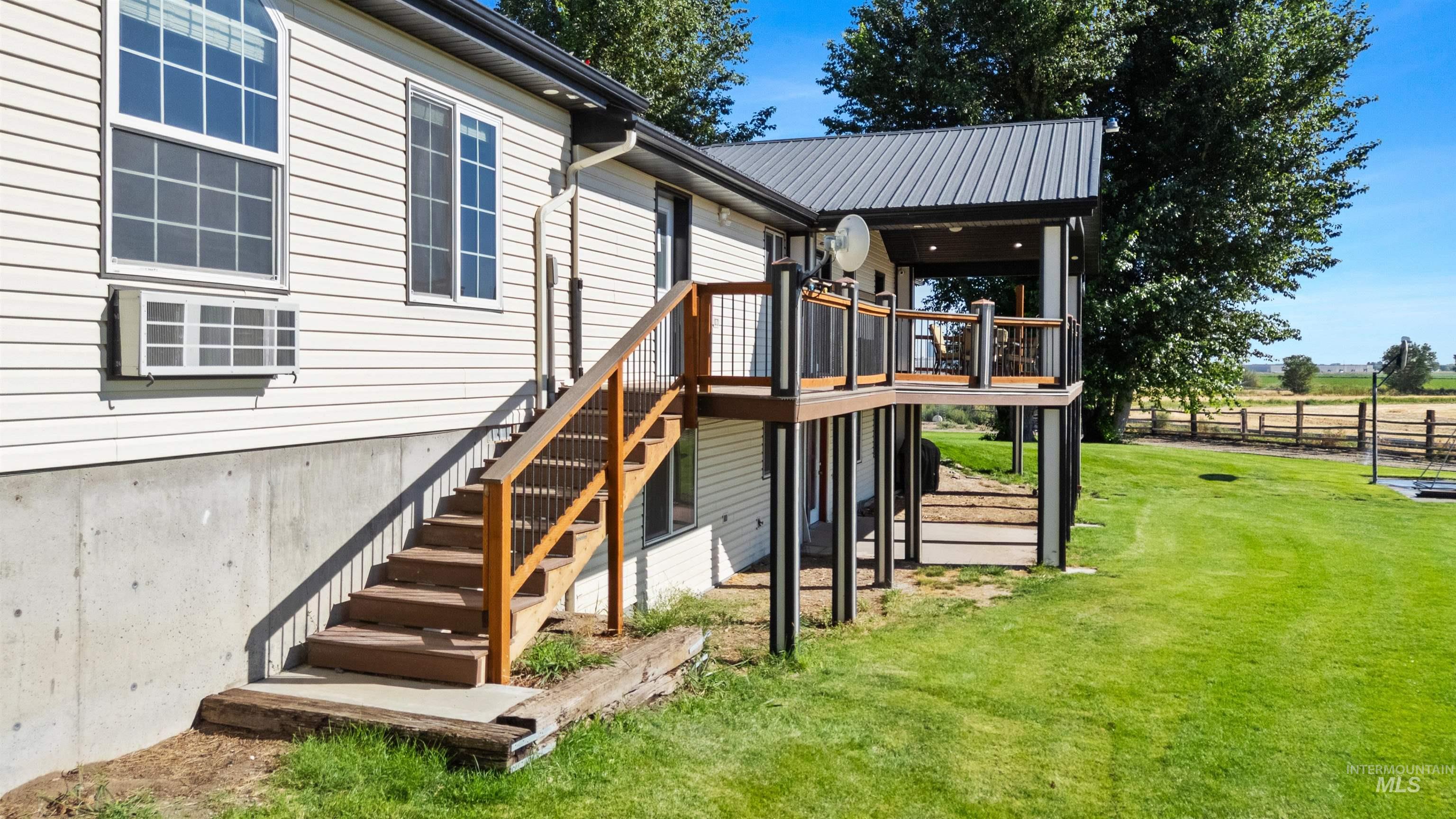 Rear view of house with stairway and a wooden deck