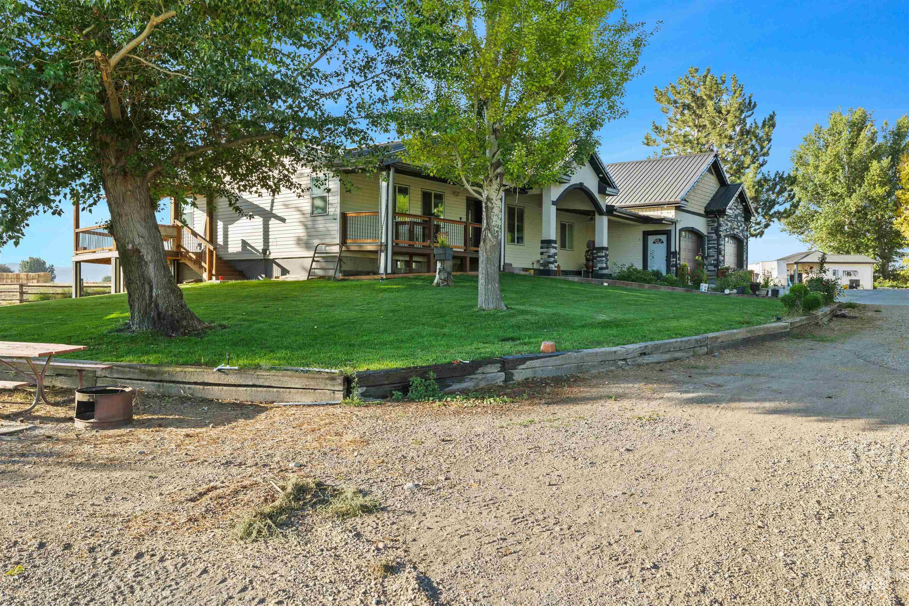 View of front of property featuring a front lawn, a standing seam roof, and a metal roof