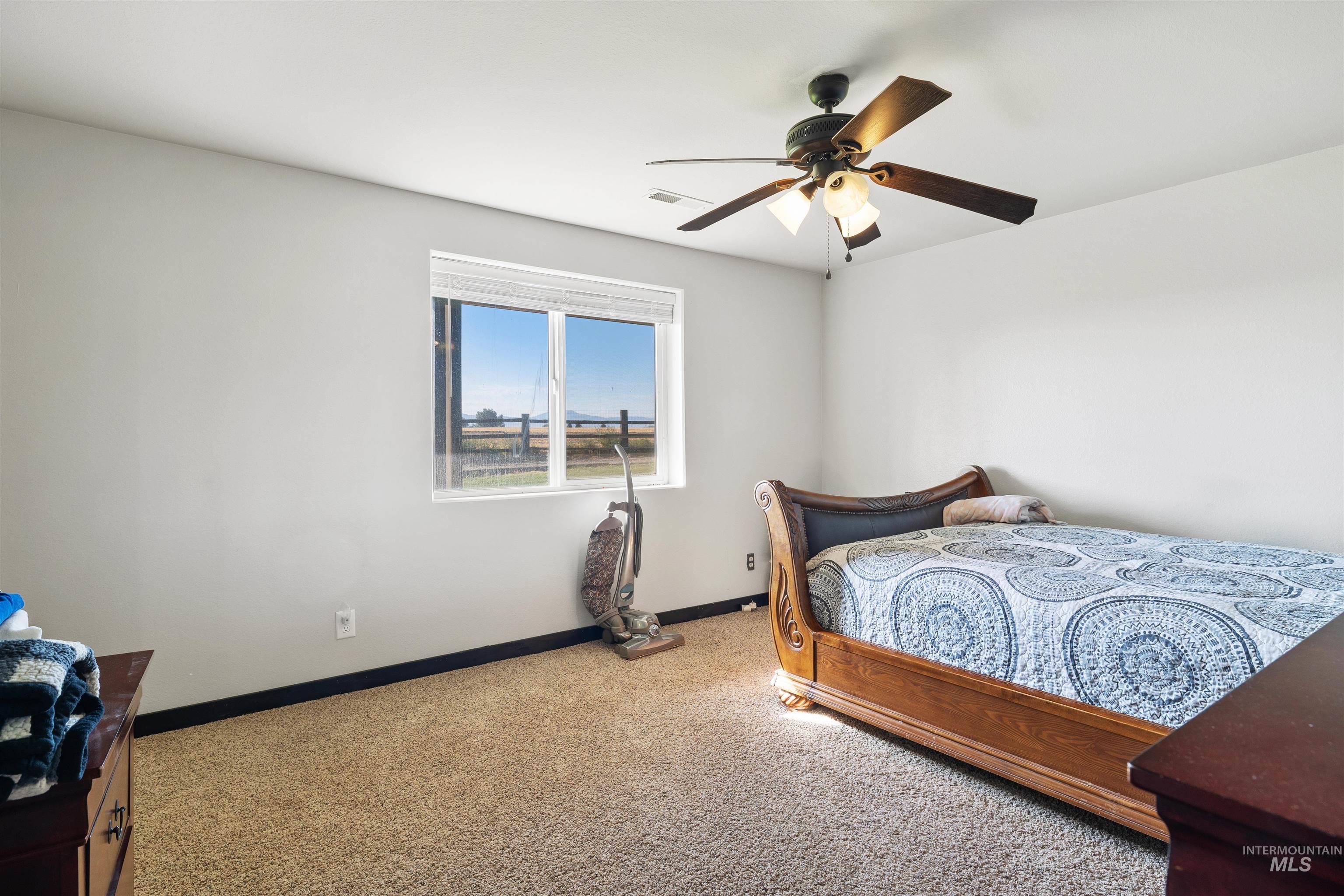 Bedroom featuring carpet floors and a ceiling fan