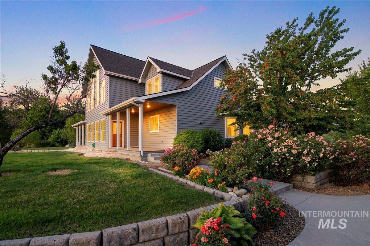View of front of house with a yard and covered porch