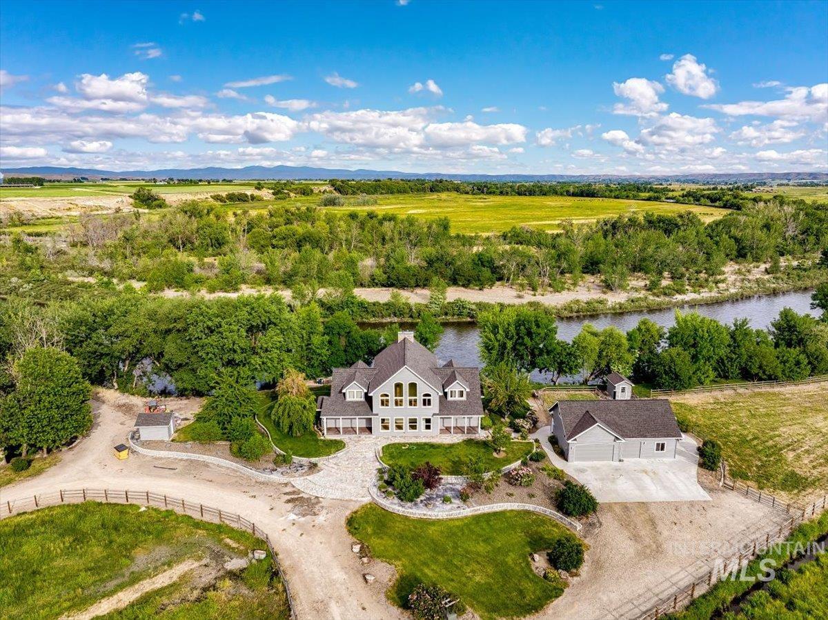 Aerial view of property and surrounding area featuring a large body of water