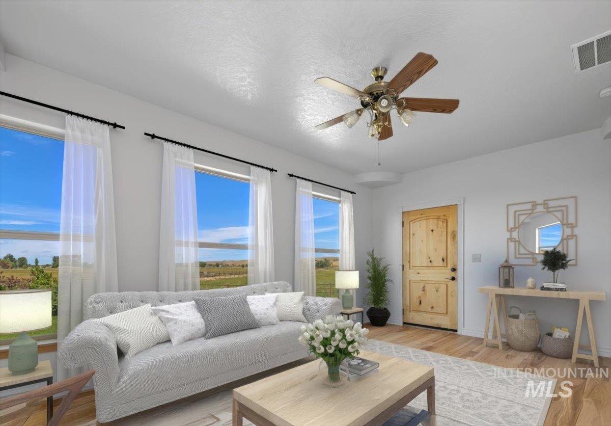 Living area with light wood-type flooring and a ceiling fan