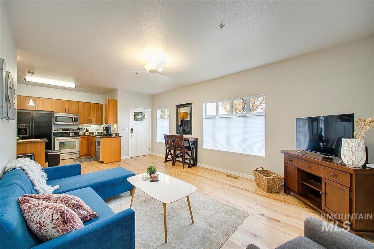 Living room with light wood-style flooring and baseboards