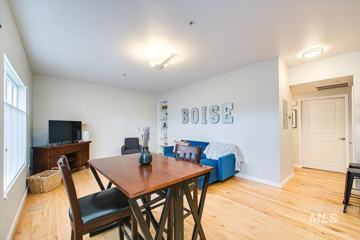 Dining area featuring light wood-style floors, healthy amount of natural light, and built in features