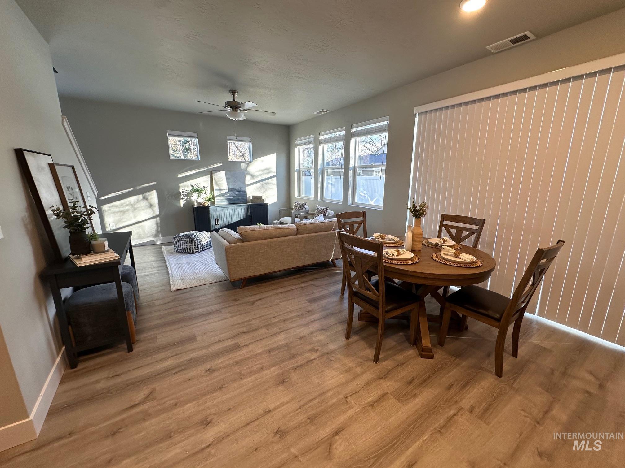 Dining space featuring a ceiling fan and light wood-type flooring