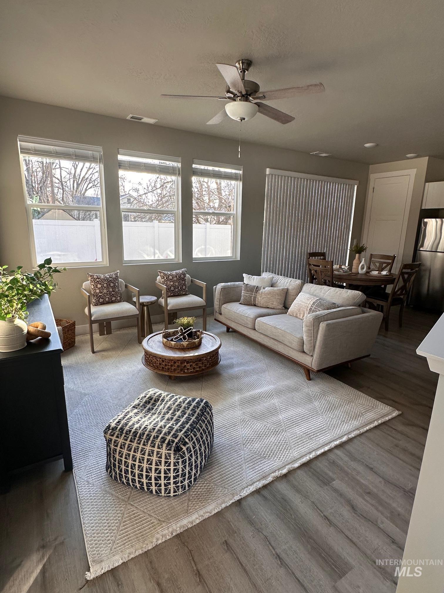 Living room with wood finished floors and ceiling fan