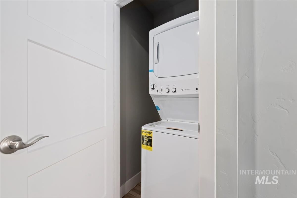 Laundry room featuring stacked washer / drying machine