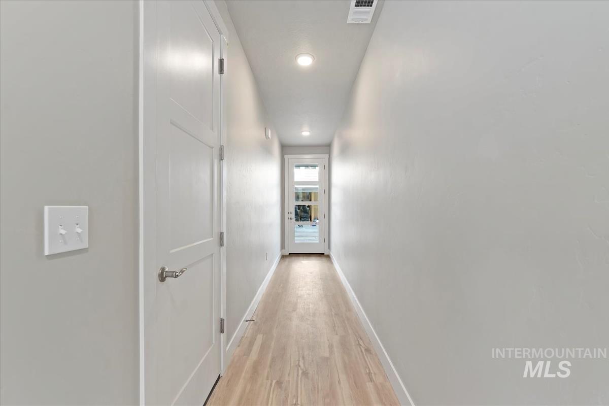 Hall featuring light wood-style flooring and recessed lighting