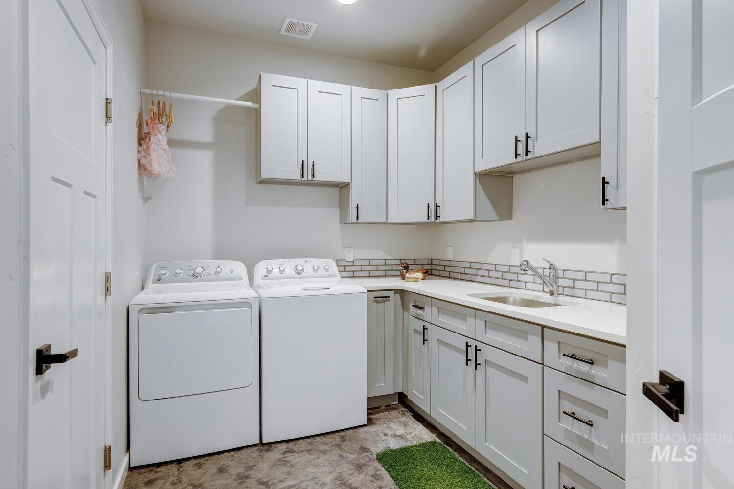 Laundry area with cabinet space and washing machine and dryer