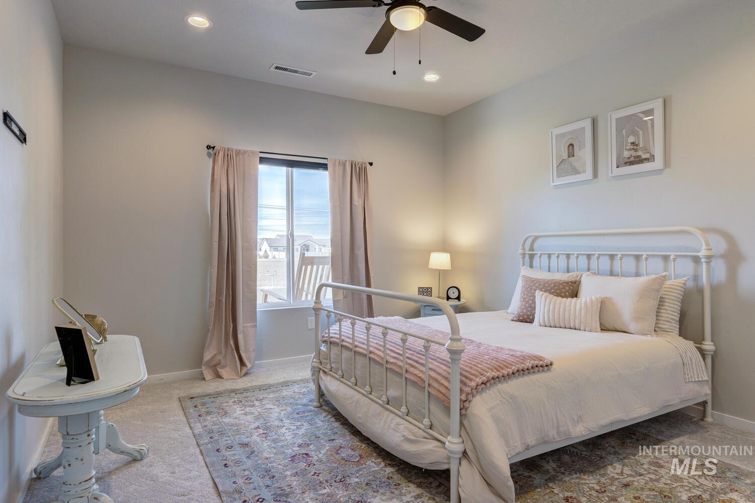 Carpeted bedroom featuring recessed lighting and a ceiling fan