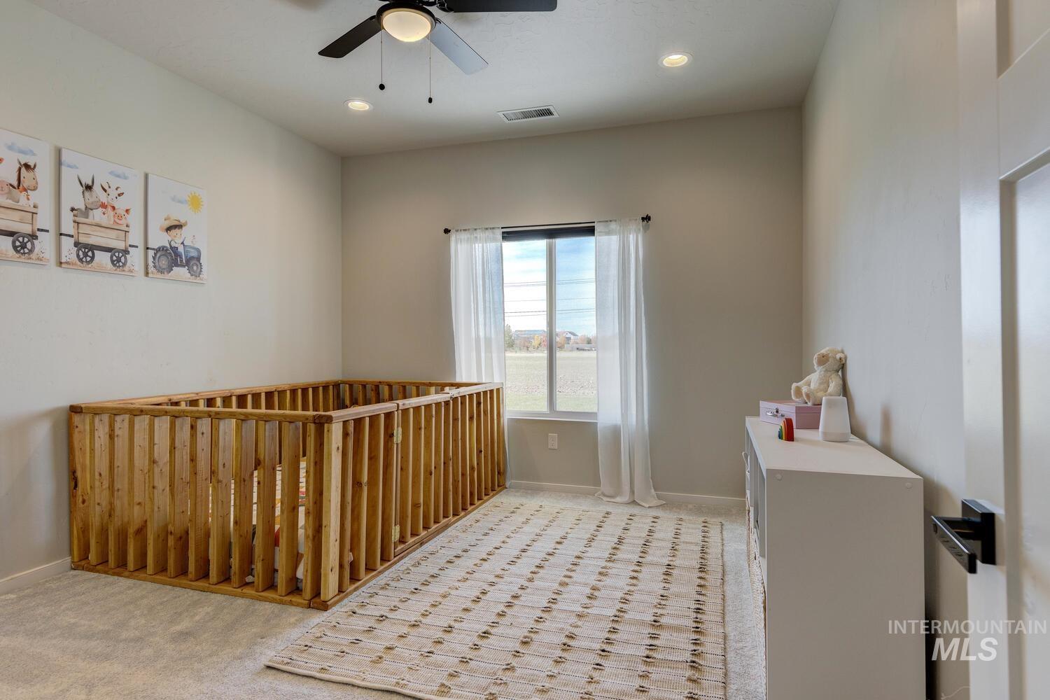 Bedroom featuring recessed lighting, ceiling fan, and light colored carpet