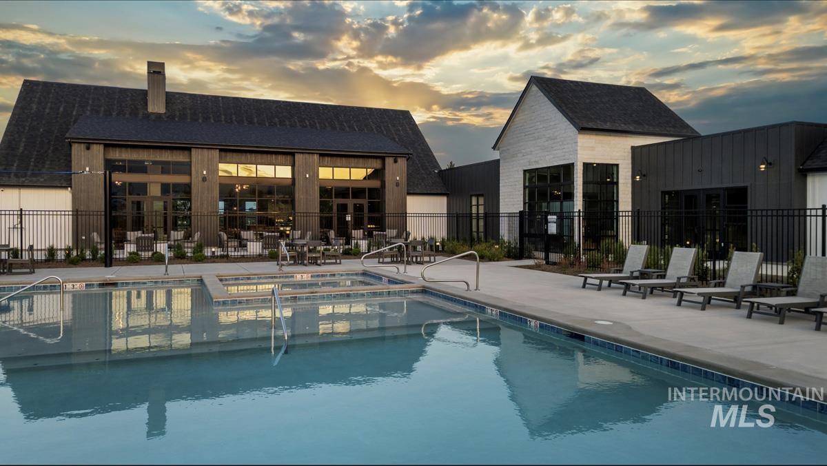 View of pool with a patio area and a pool with connected hot tub