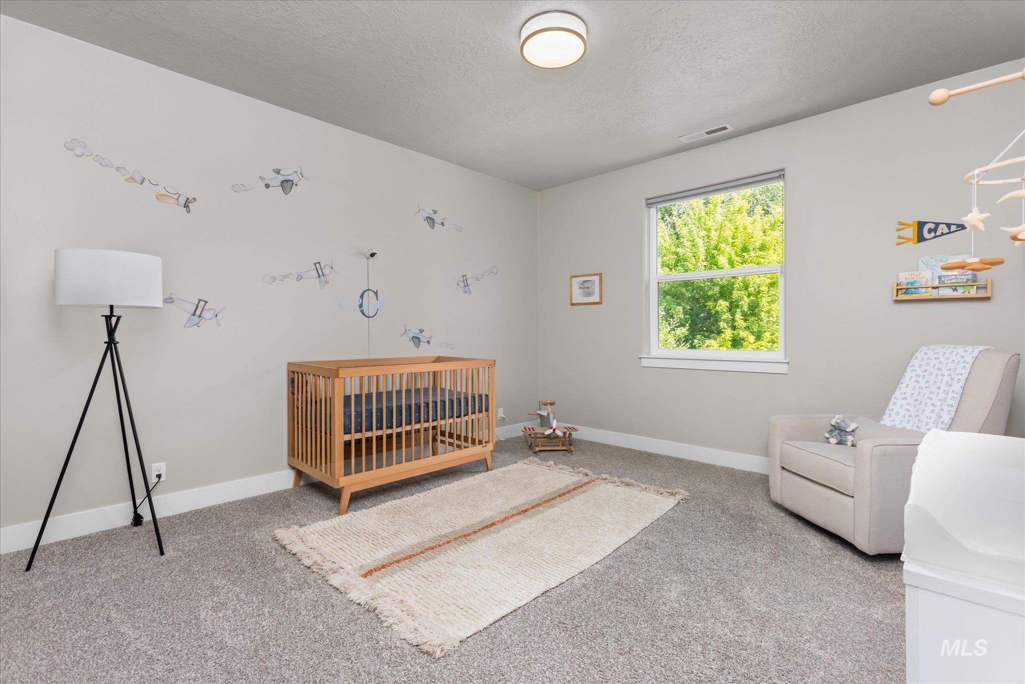 Bedroom featuring carpet and a textured ceiling