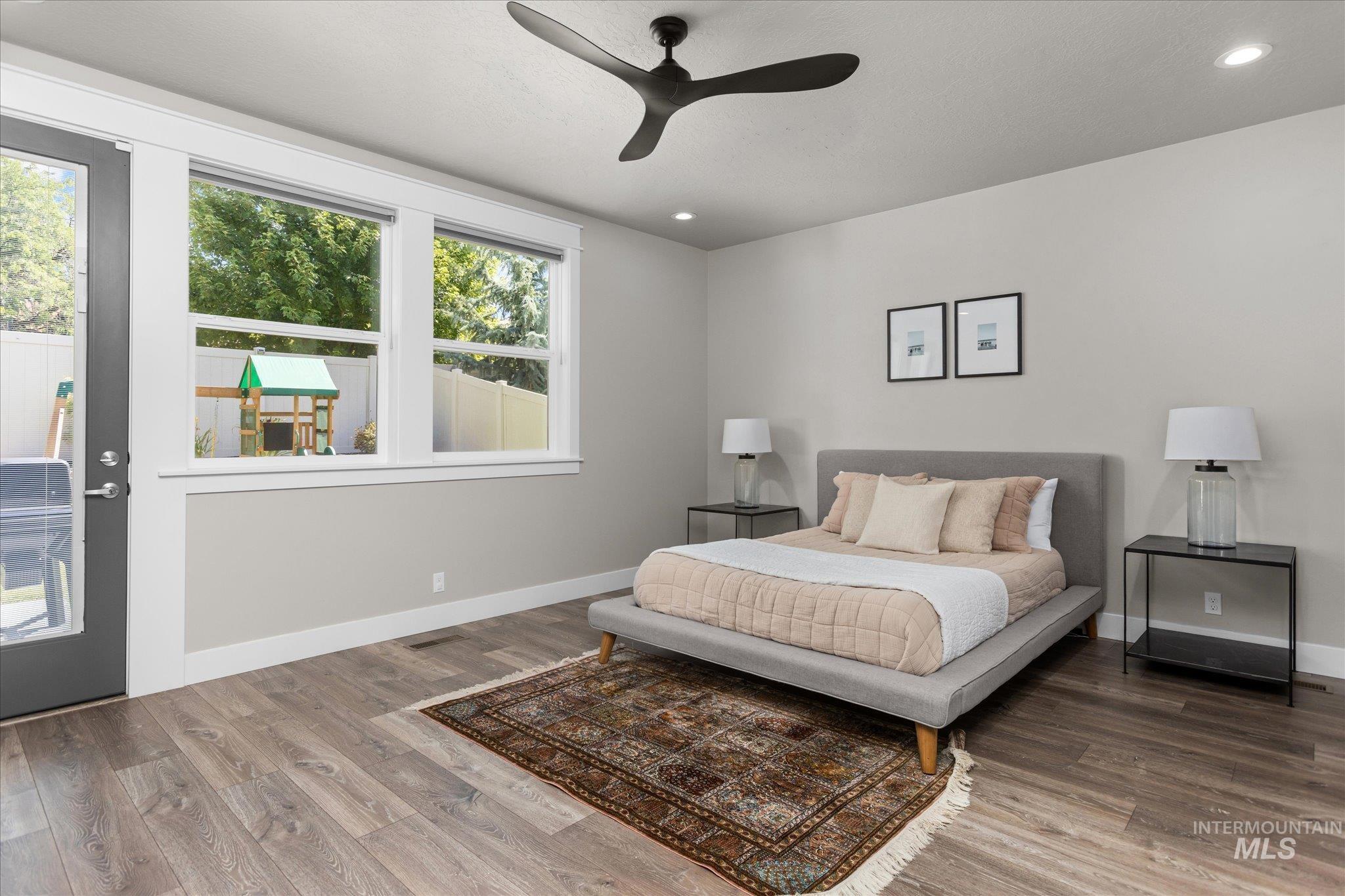 Bedroom with wood finished floors, recessed lighting, and a ceiling fan