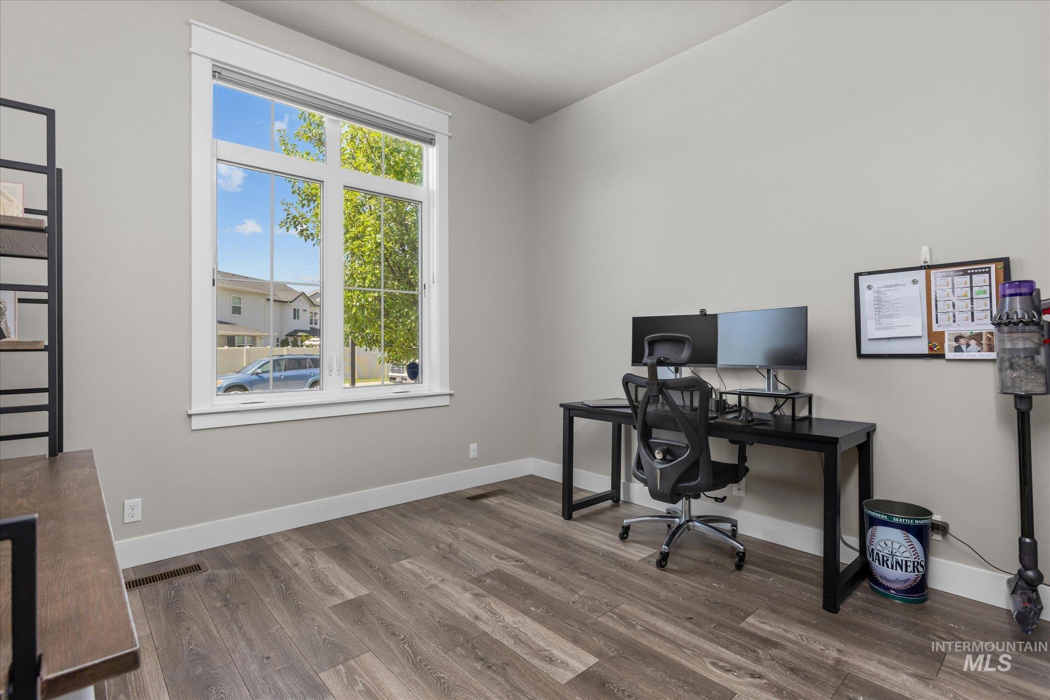 Office featuring wood finished floors and baseboards