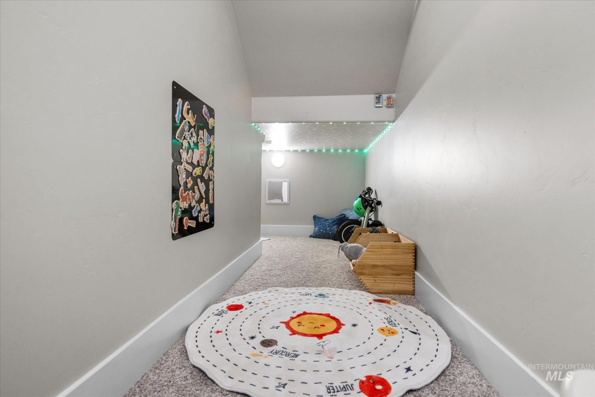 Game room with carpet and lofted ceiling