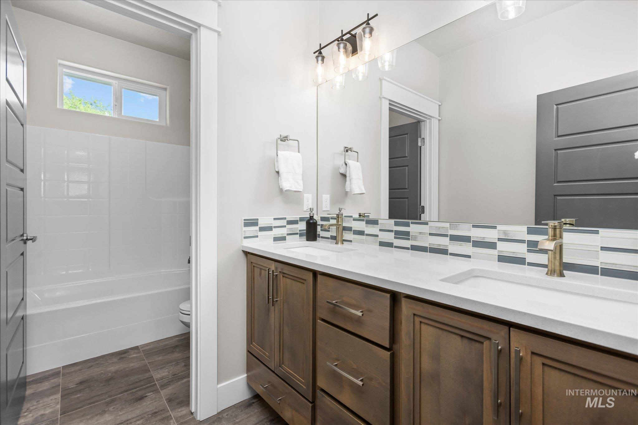 Bathroom featuring backsplash and double vanity