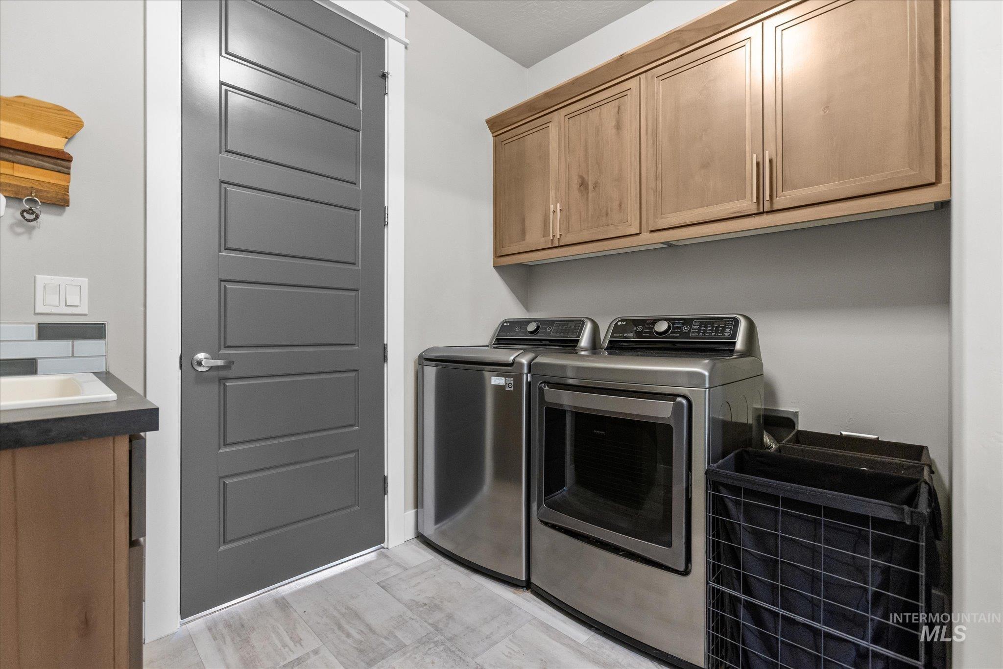 Laundry area with washing machine and clothes dryer and cabinet space