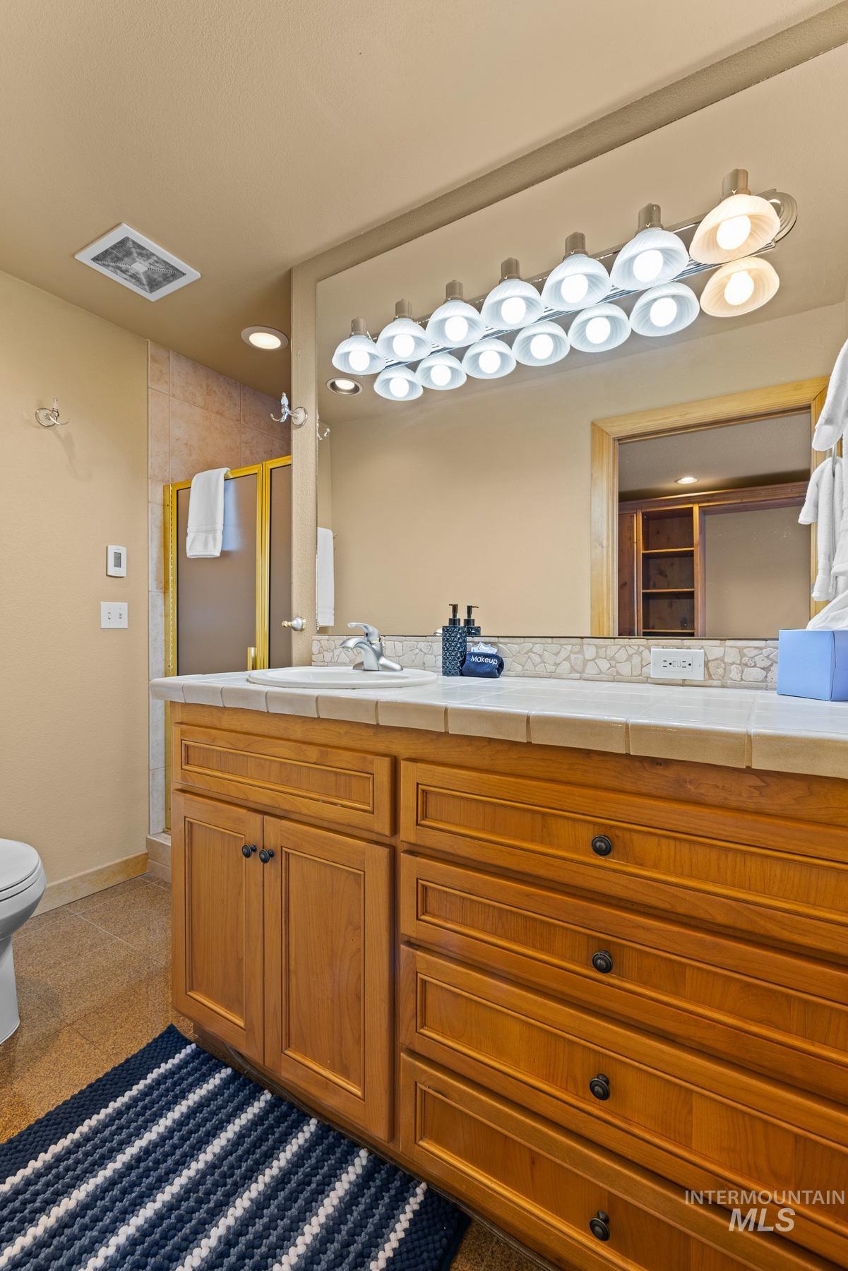 Bathroom featuring double vanity and heated floors