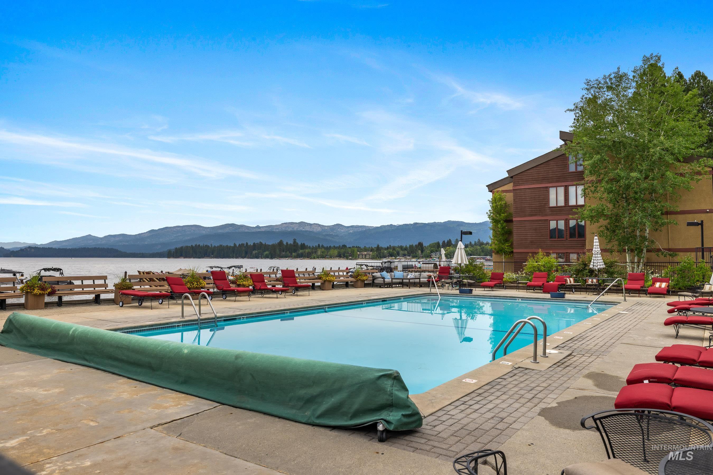 Community pool featuring a mountain view and a patio