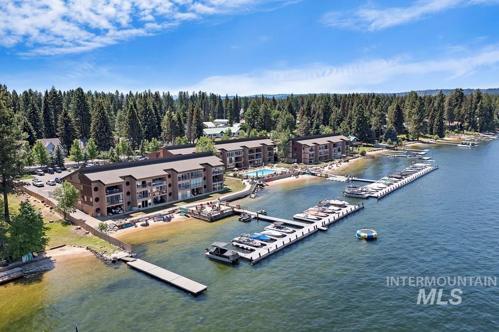 Drone / aerial view of numerous boat docks and a nearby body of water