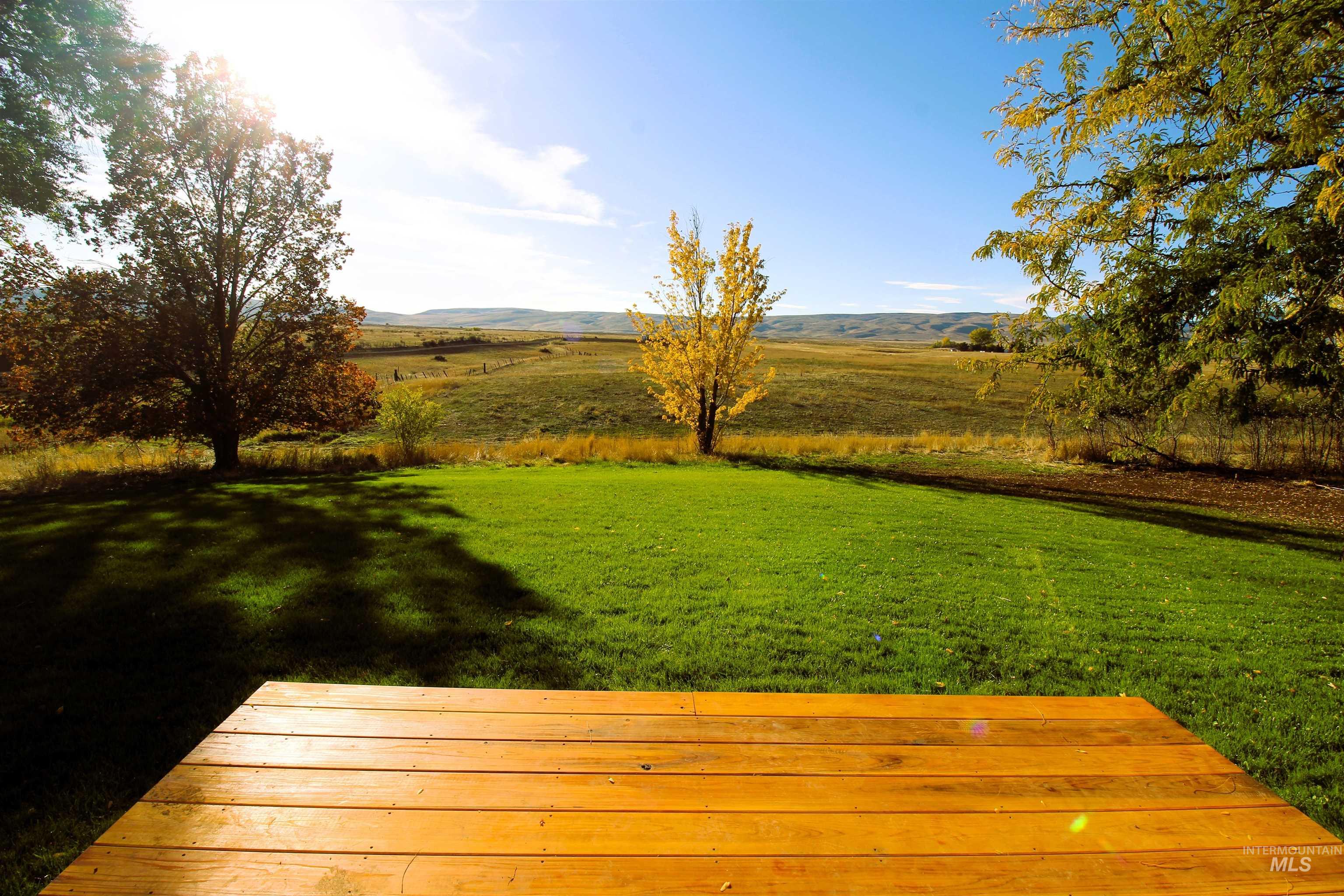 View of green lawn with a rural view