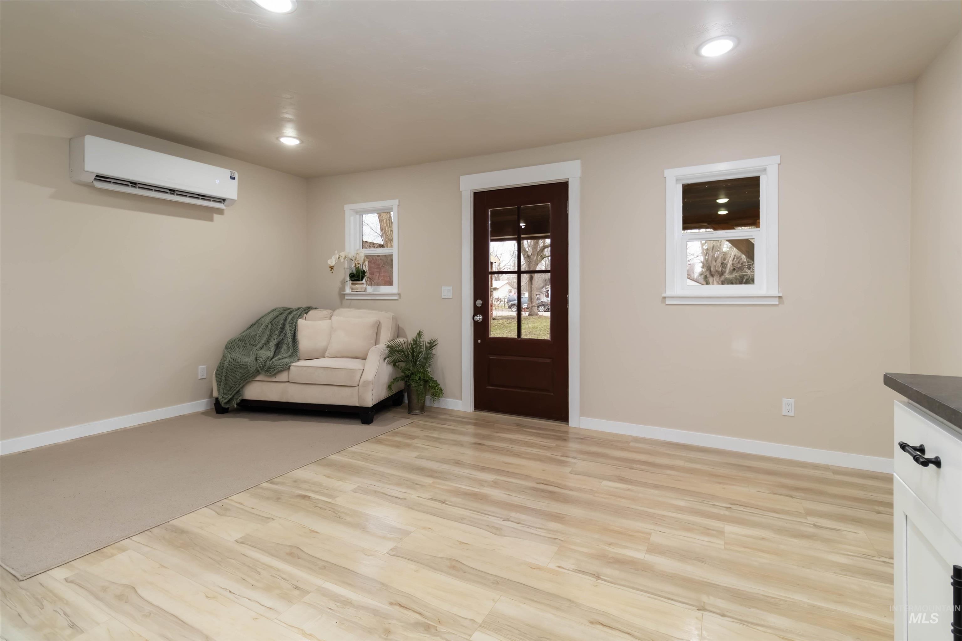 Foyer entrance featuring light wood finished floors and recessed lighting
