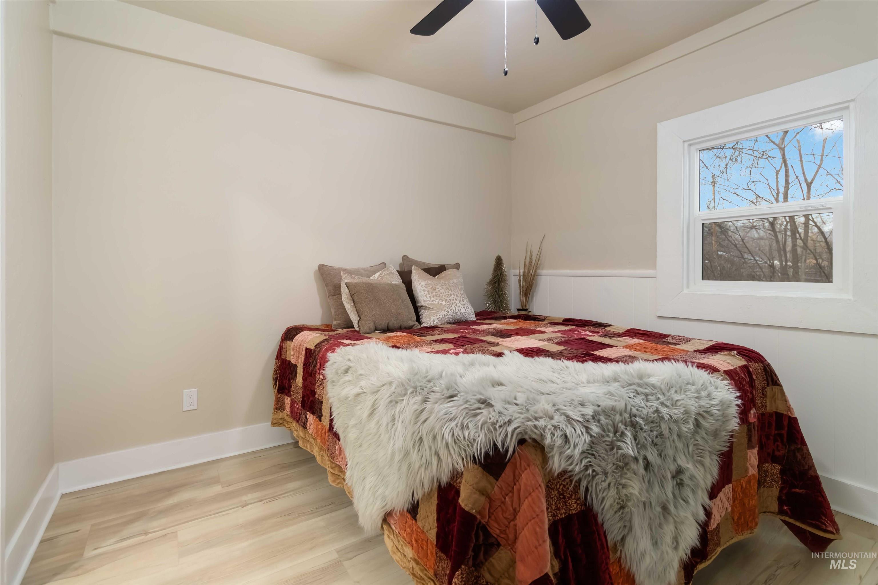 Bedroom with light wood-type flooring and ceiling fan