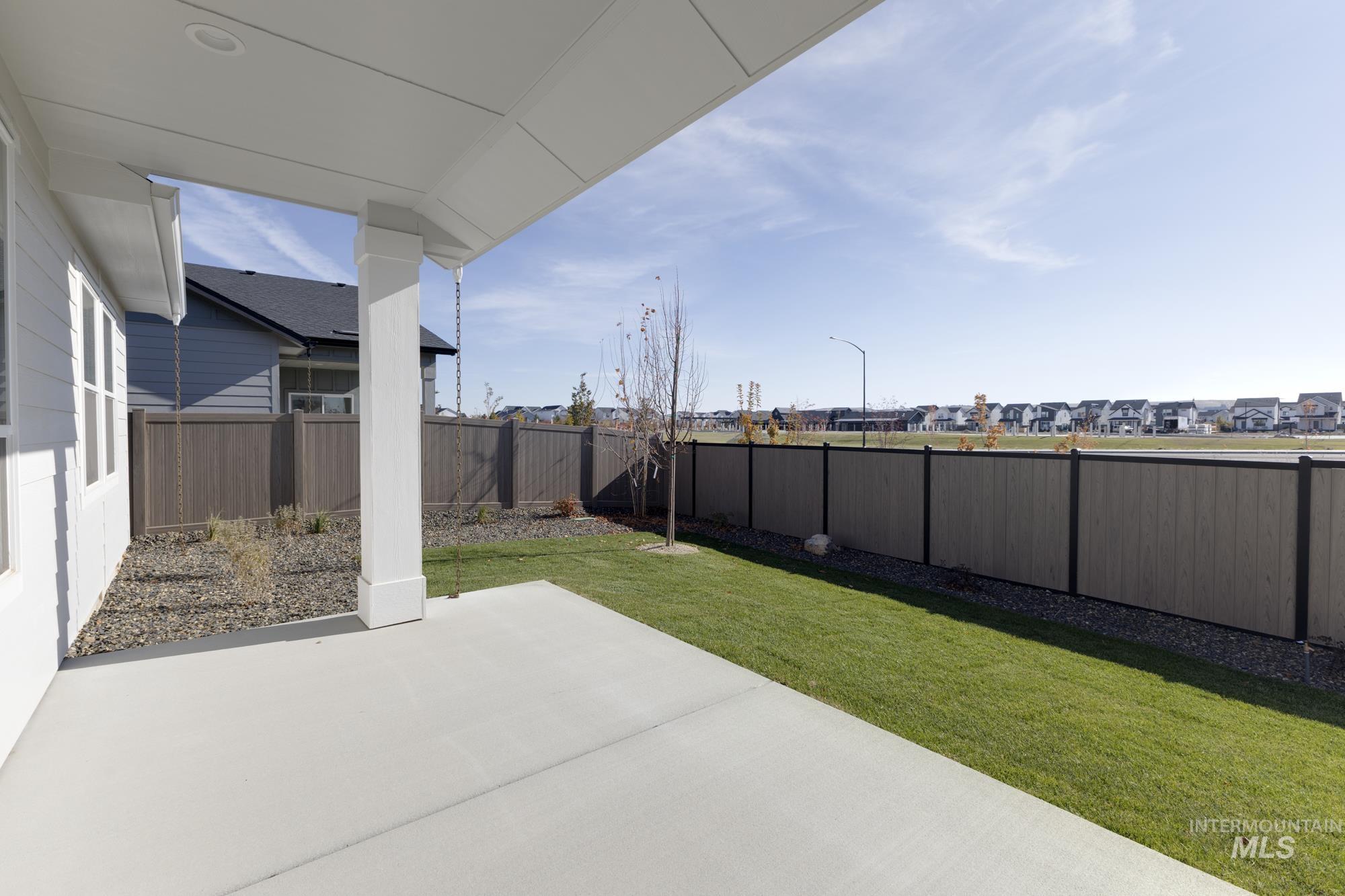 Fenced backyard with a patio and a residential view