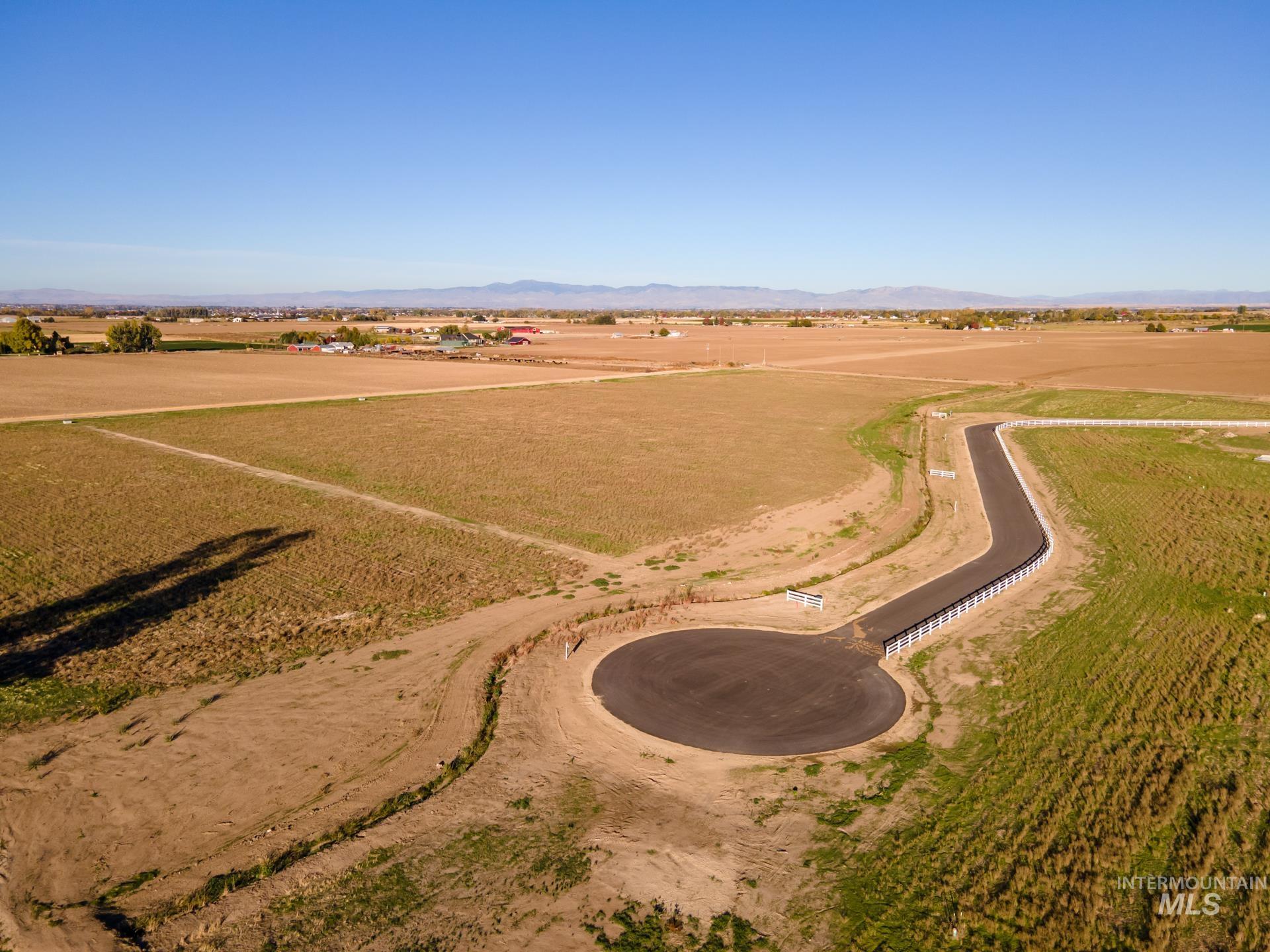 Aerial overview of property's location with rural landscape and a mountain backdrop