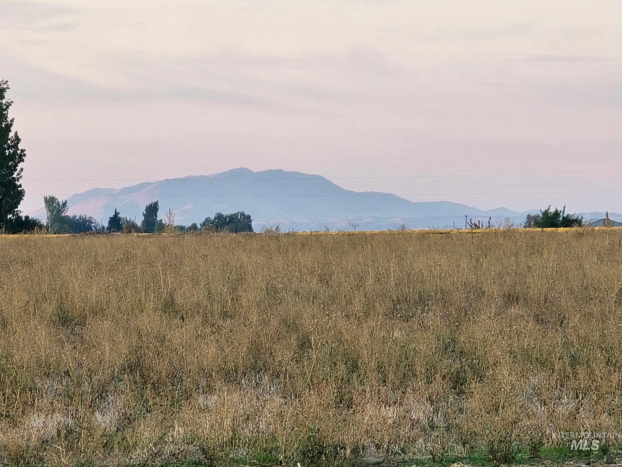 View of mountain backdrop with rural landscape