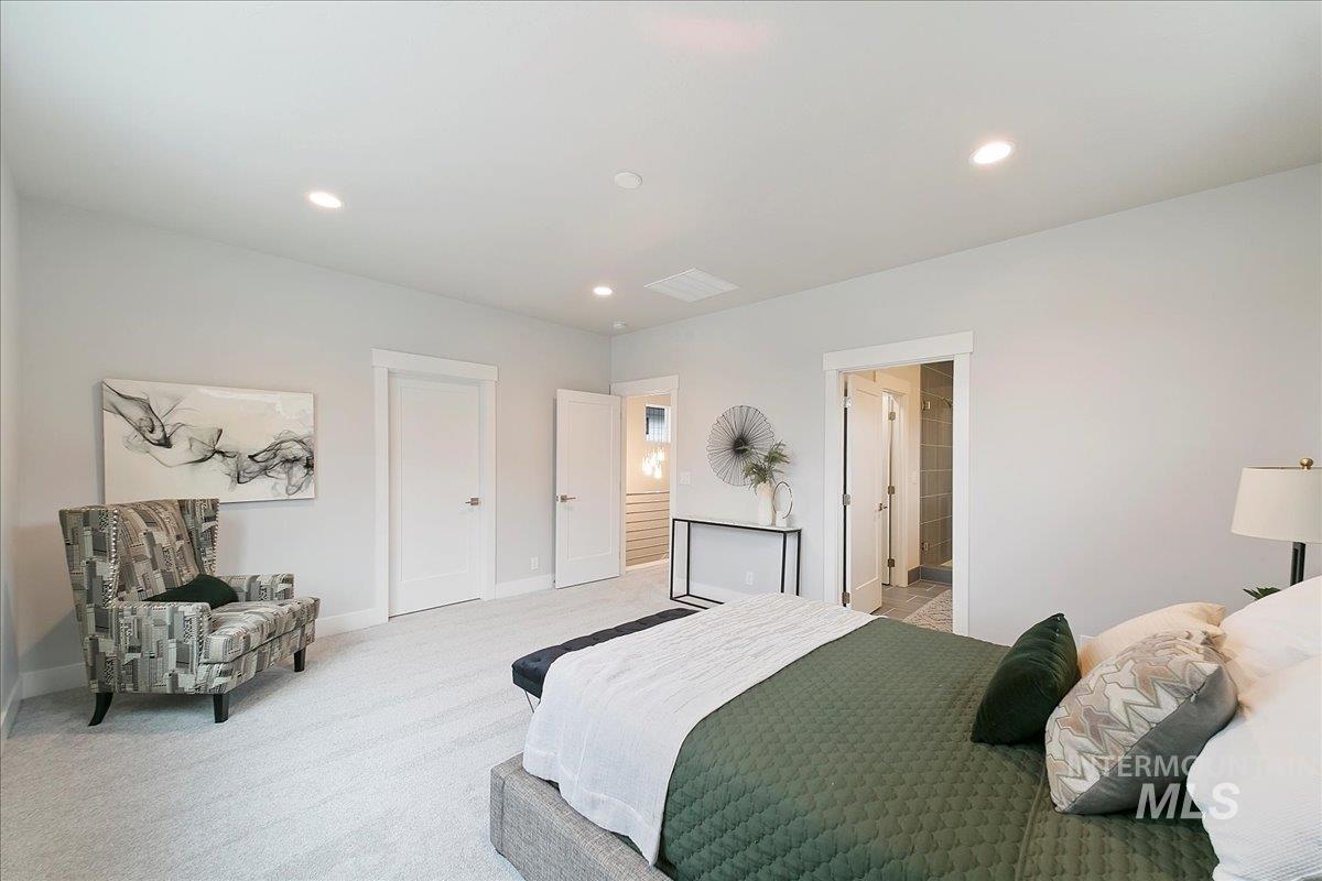 Carpeted bedroom with recessed lighting and baseboards